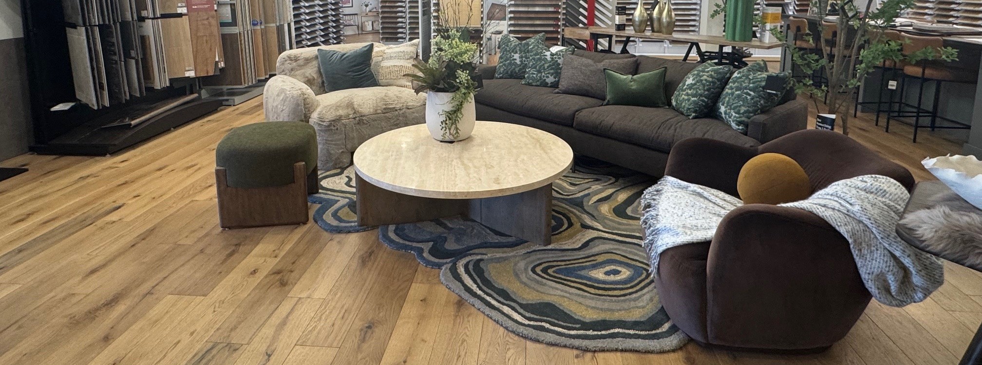 black and white pattered area rug in midcentury living room with green couch